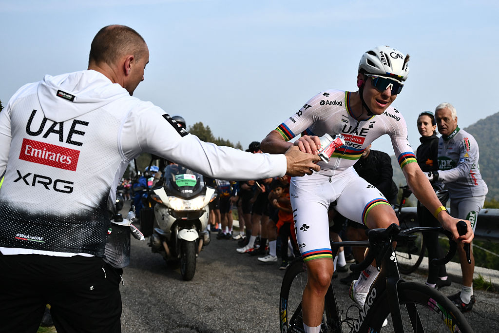 UAE Team Emirates&rsquo;s Slovenian rider Tadej Pogacar grabs a hydration bottle (bidon) as he cycles in a lone breakaway in the Passo Di Ganda ascent during the 119th edition of the Giro di Lombardia (Tour of Lombardy), a 238km cycling race from Como to Bergamo on October 11, 2025. (Photo by Marco BERTORELLO / AFP)