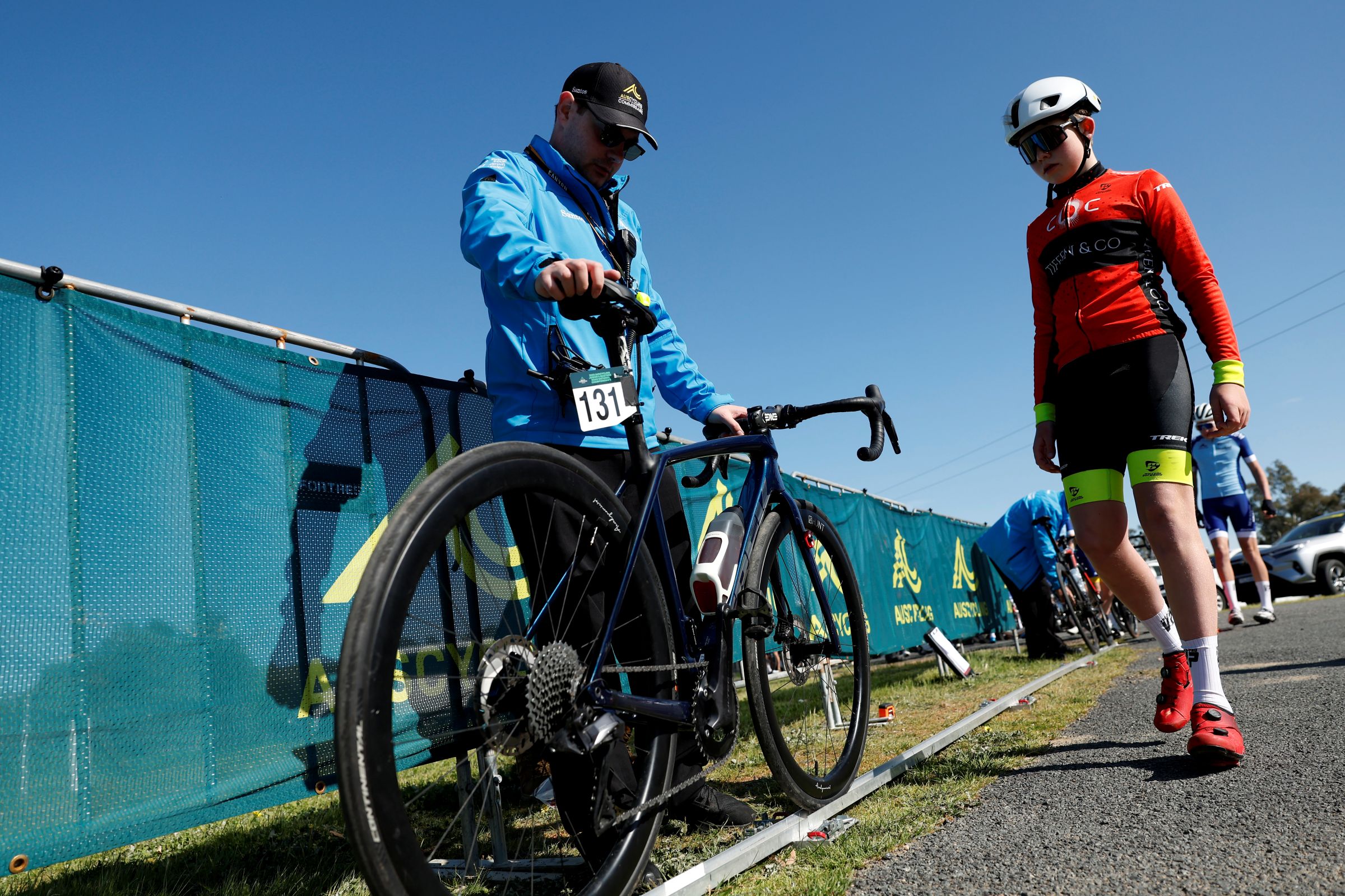 David Moiler, an AusCycling road commissaire (official), checks the rollout distance of a bicycle at bike check at a National Championships