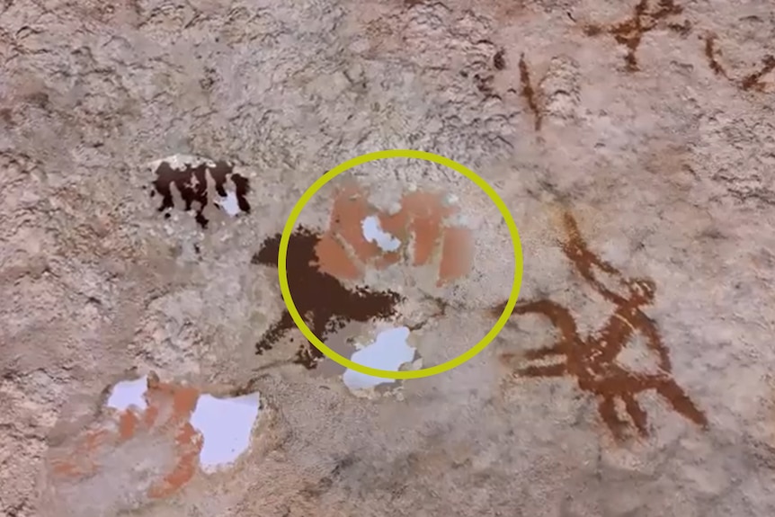 A cave wall with sections highlighted to show a slight hand print.