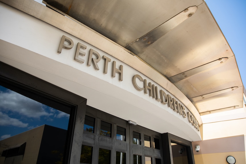 The words 'Perth Children's Court' above the entry to a building, seen from the side.