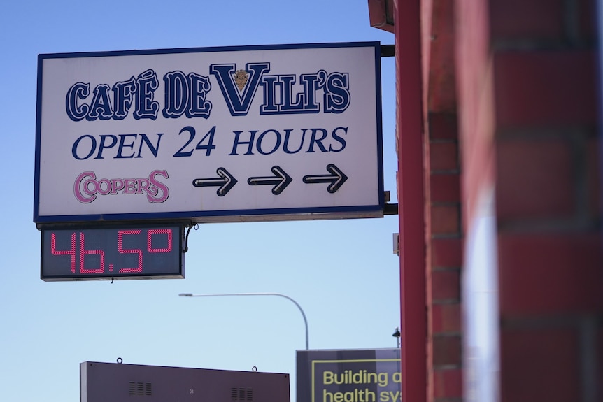 A sign with a digital temperature readout of 46.5C.