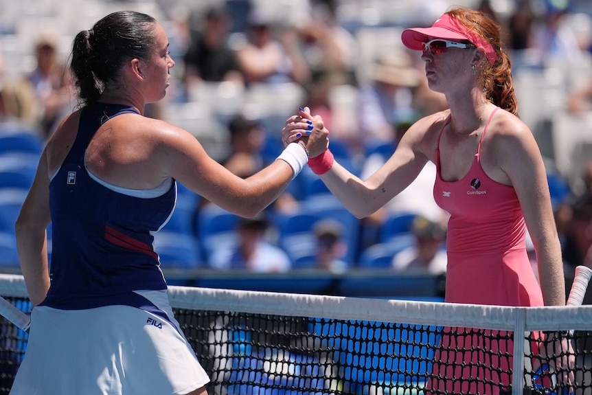 Maya Joint shakes hands with Tereza Valentova at the net at the Australian Open.