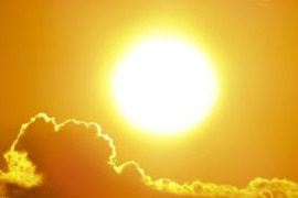 A blazing orange sun sits above golden clouds.