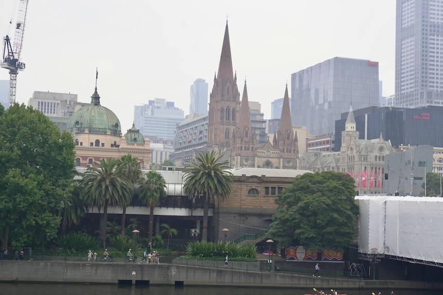A cloud of smoke covers buildings in the CBD, flinders street station