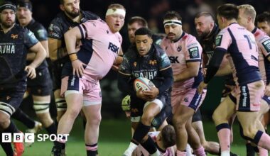 Keelan Giles of Ospreys has the ball surrounded by Cardiff players