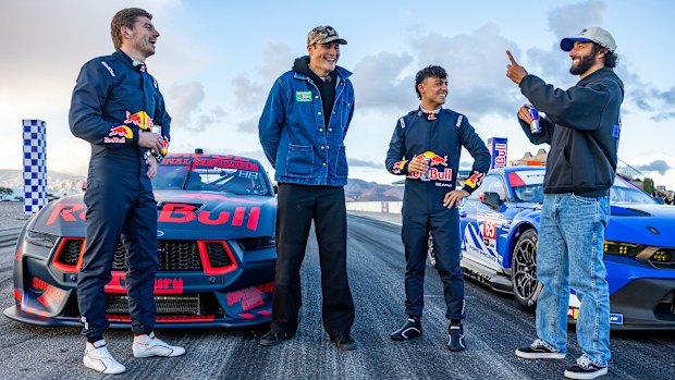 Max Verstappen, Jeremiah Burton, Arvid Lindblad and Daniel Ricciardo pose in front of a V8 Supercar and a Ford Mustang GT3 during a Red Bull promosion in Las Vegas, Nevada.