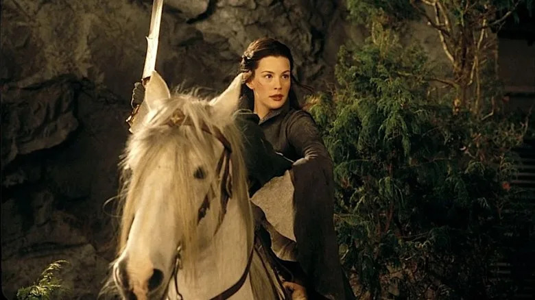 Arwen on a horse with drawn sword in The Lord of the Rings movies