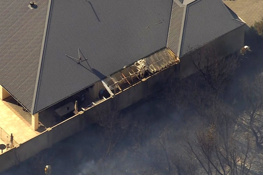 The patio roofing in a house is burnt by the fire. 