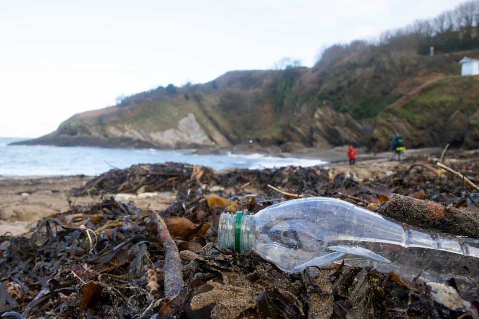 Used plastic washed up on beach in North Devon, UK