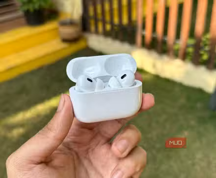 AirPods Pro 2 with case open being held in a man's hand