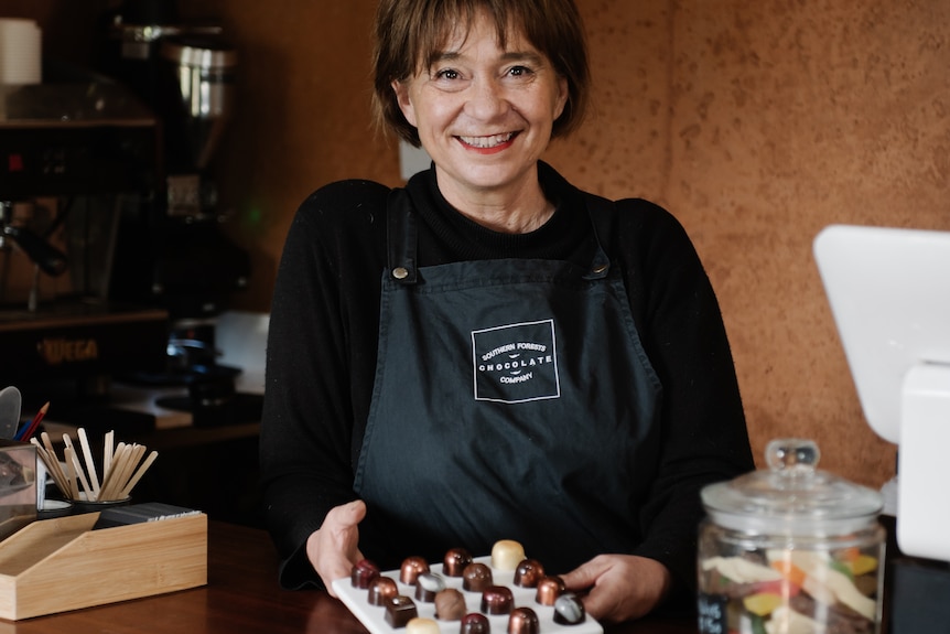 a lady in all black having her photo taken.