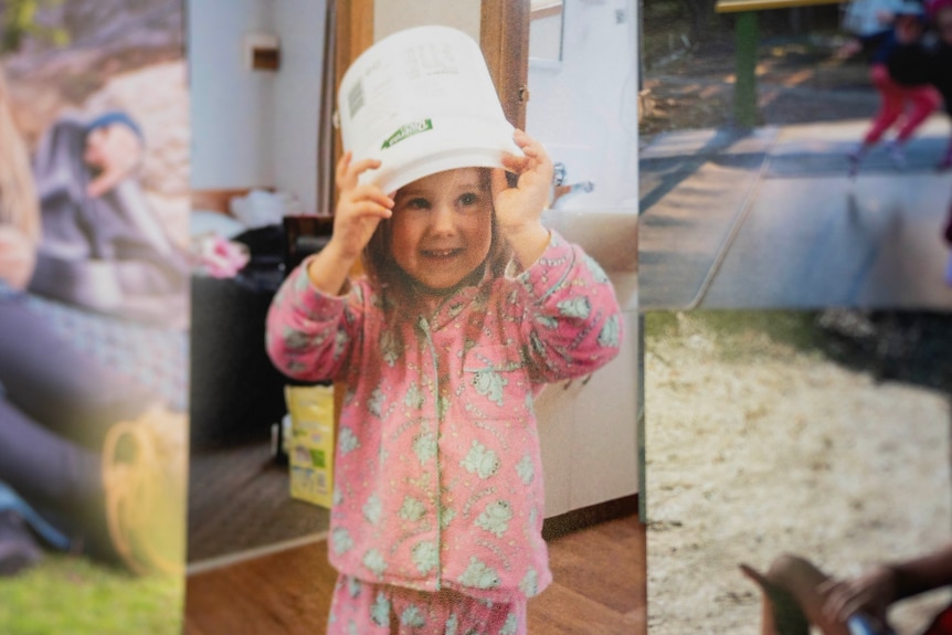 A photo of a young girl on the wall.