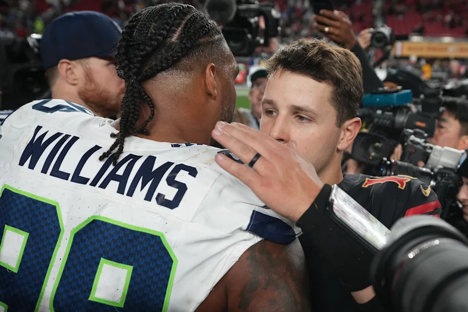 San Francisco 49ers quarterback Brock Purdy reacts with Seattle Seahawks defensive end Leonard Williams.