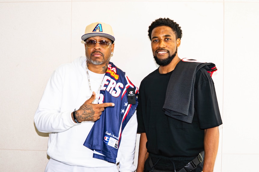 Allan Iverson stands next to Bryce Cotton.