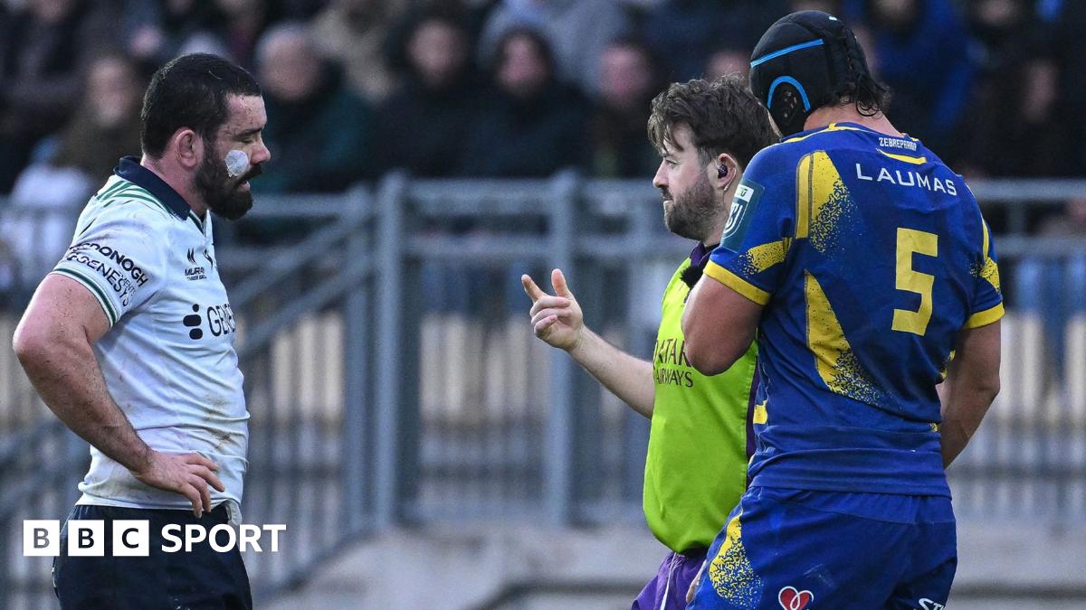 Referee Ben Whitehouse speaks to both captains