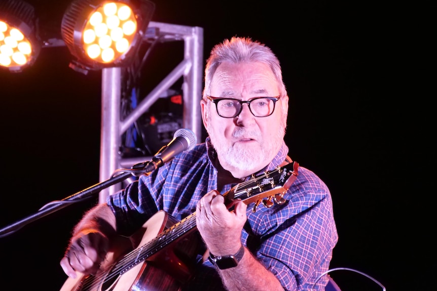 John WIlliamson with guitar singing.