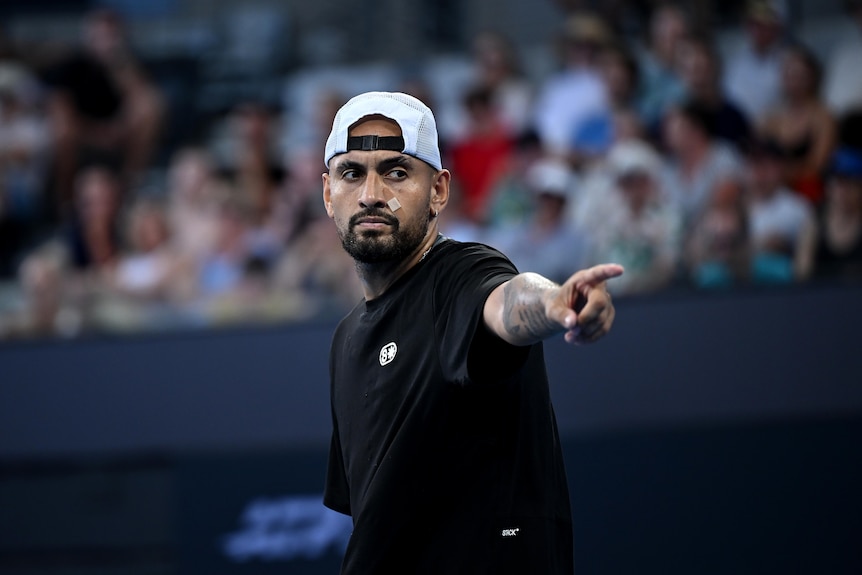 Nick Kyrgios points to one side