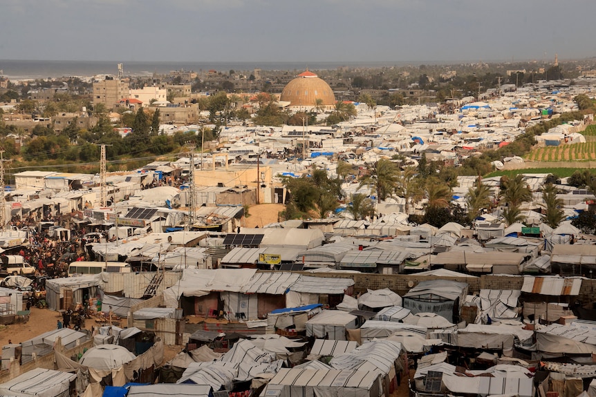 An aerial view of streets lined with tents. 