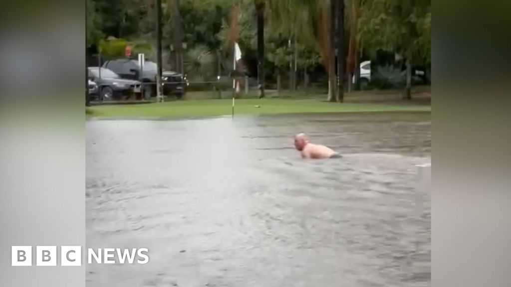 Man swims in flooded Sydney golf course after heavy rain