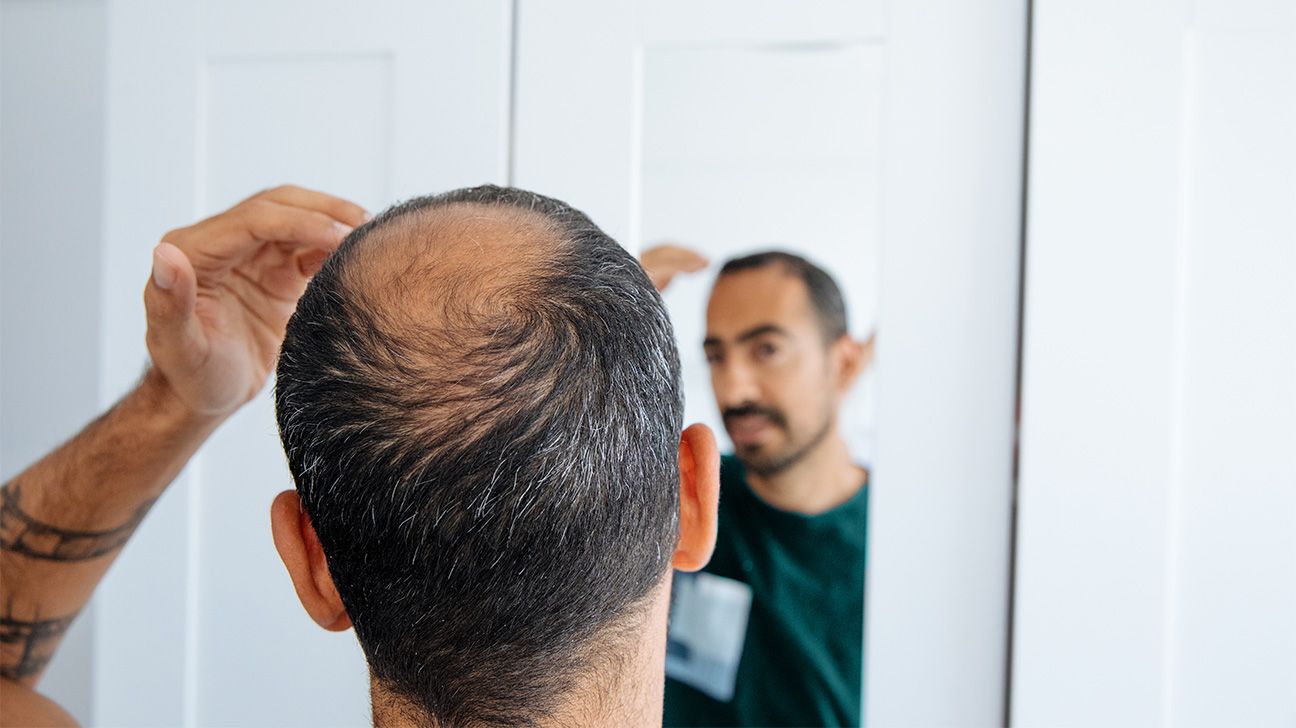 Male checking his hair in the mirror