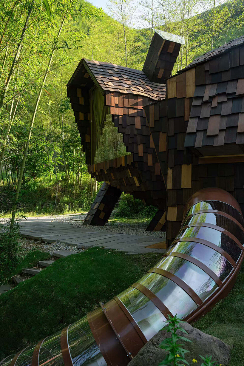 patchwork exterior of 'cat house' in china's anji forest is clad in discarded bamboo tiles