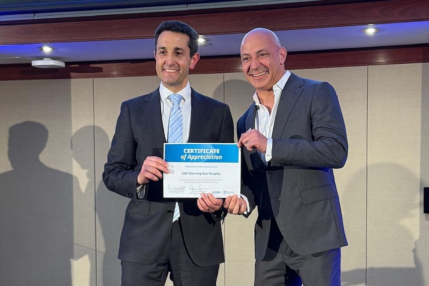 Two men with the presentation of some award.