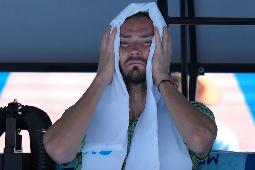 Daniil Medvedev with a towel over his head at the Australian Open.