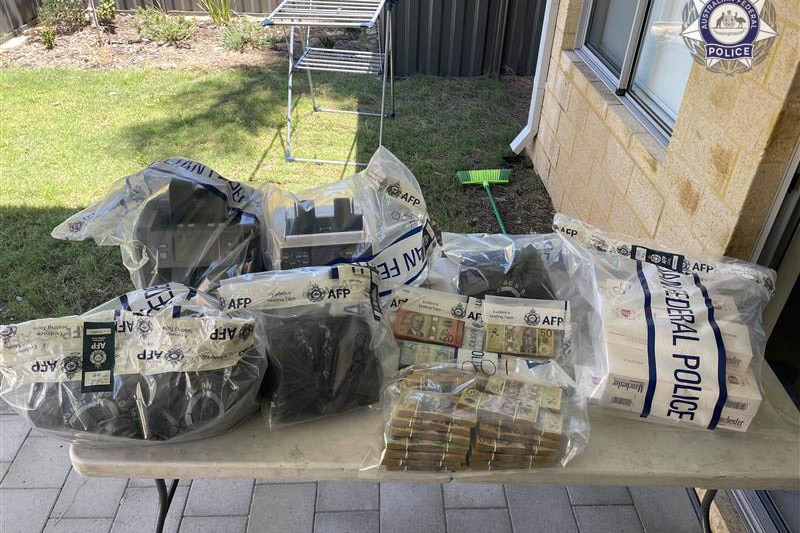 Cash and AFP evidence bags on a trestle table.