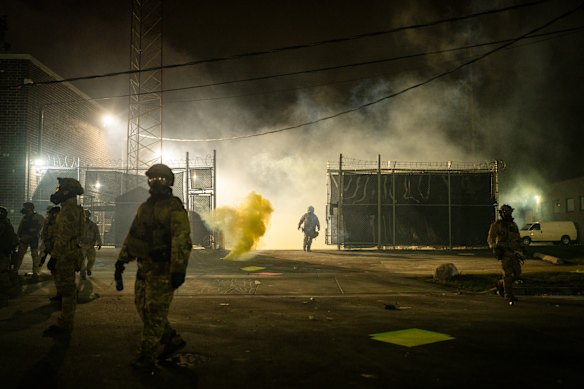 Tear gas is deployed as dozens of protesters gather at the entrance of the Immigration and Customs Enforcement facility in Chicago.