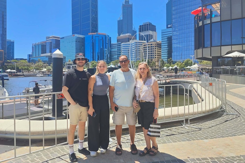 Ioannis pictured with three relatives at a wharf
