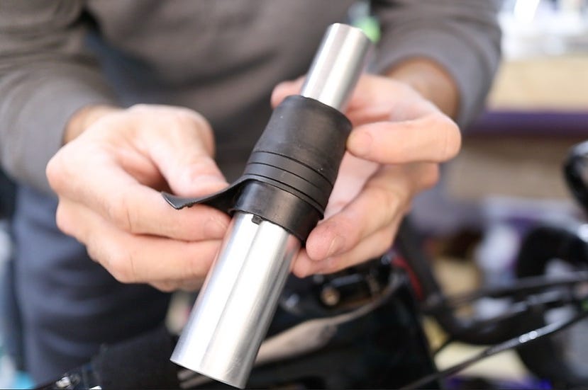 handling a metal cylindrical object with a black rubber grip