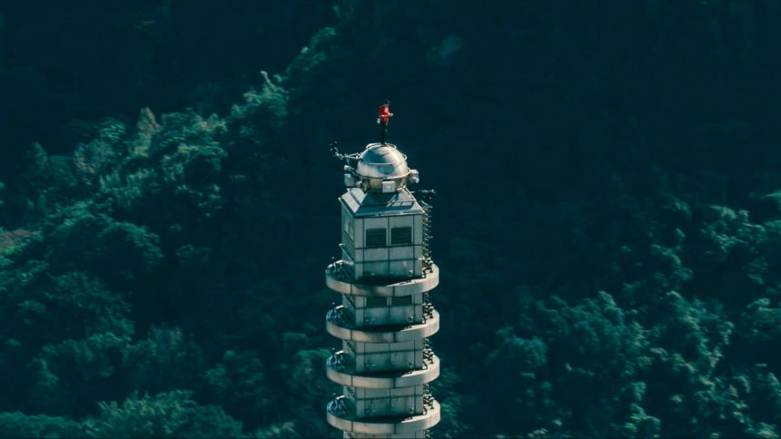 Honnold standing at the top of Taipei 101 after completing his free solo climb.