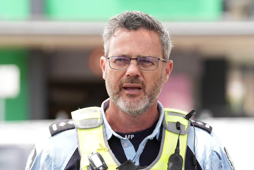 A police officer wearing a vest.