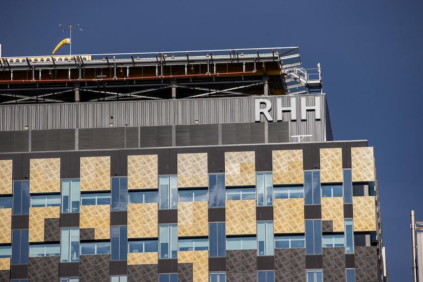 The exterior of a muilti-storey building bearing the letters "RHH".