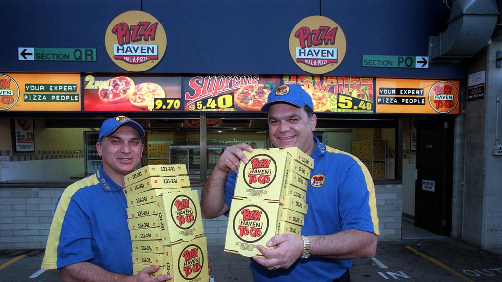 Pizza Haven operators Louis Christou (l) with brother Bill after securing rights to sell pizzas at Football Park 20 Jul 2000.
