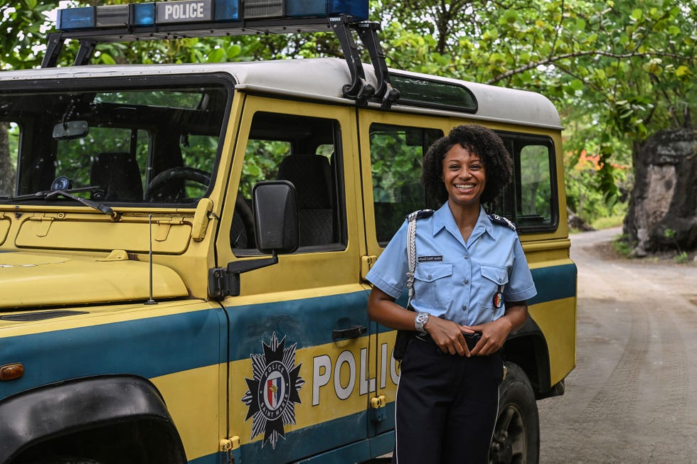 police vehicle with an officer standing alongside