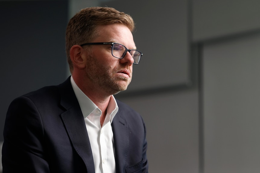 A man in a suit jacket and shirt.