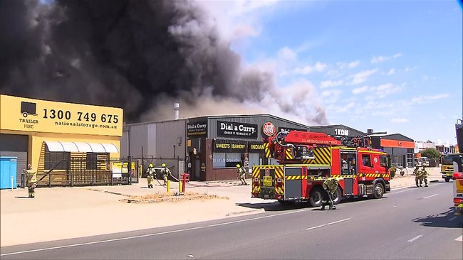 Smoke is billowing from a factory or warehouse on the corner of Regency Rd and South Rd in Croydon Park.