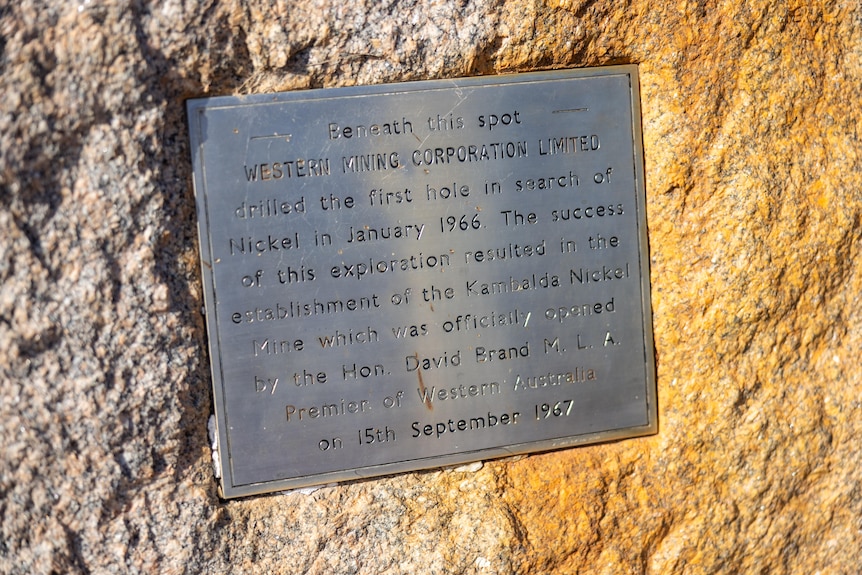 A commemorative plaque on a rock on a mine site.  