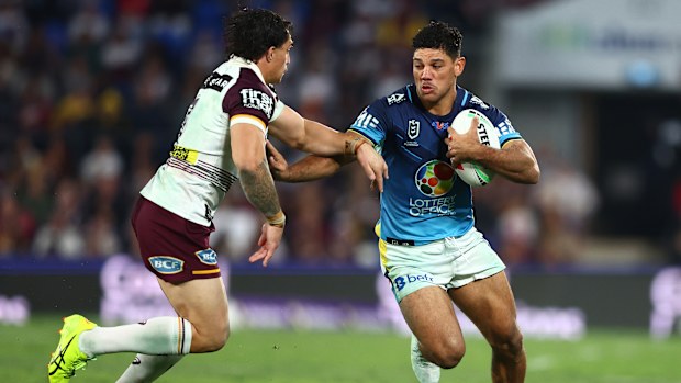 Brian Kelly of the Titans looks to break a tackle during his side's clash with the Broncos. 