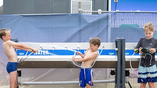 Henry, 10, and Toby, 7, McGarry from Faulconbridge hose off after a swim at Penrith Beach on a previous scorcher in early December.