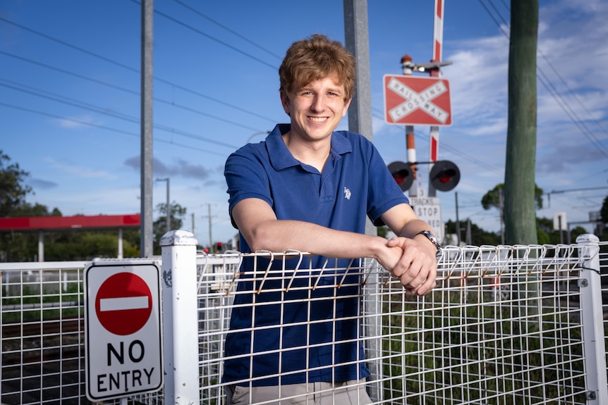 A man next to a level crossing
