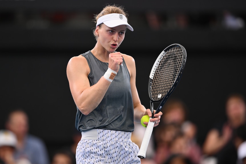 Luidmila Samsonova punching the air after a point with a racquet in her hand