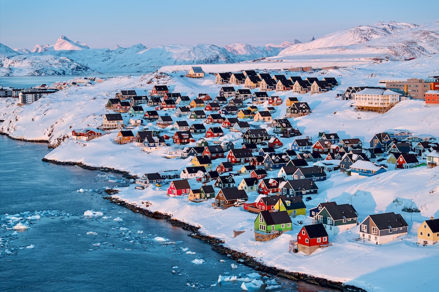 Houses on a snowy shore in Greenland.