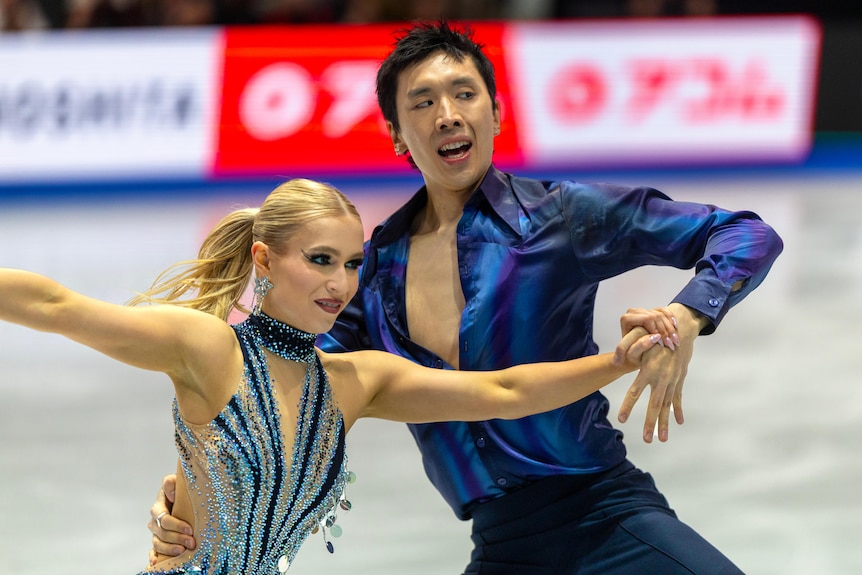 Holly Harris and Jason Chan look to one side as they skate