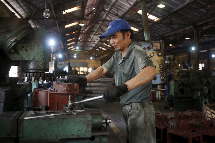 man with tools in factory.