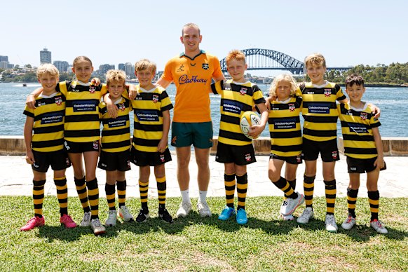 Max Jorgensen poses with members of his junior rugby club, the Balmain Wolves.