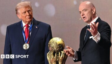 US President Donald Trump (left) and Fifa president Gianni Infantino (right) either side of the World Cup trophy at the 2026 tournament draw