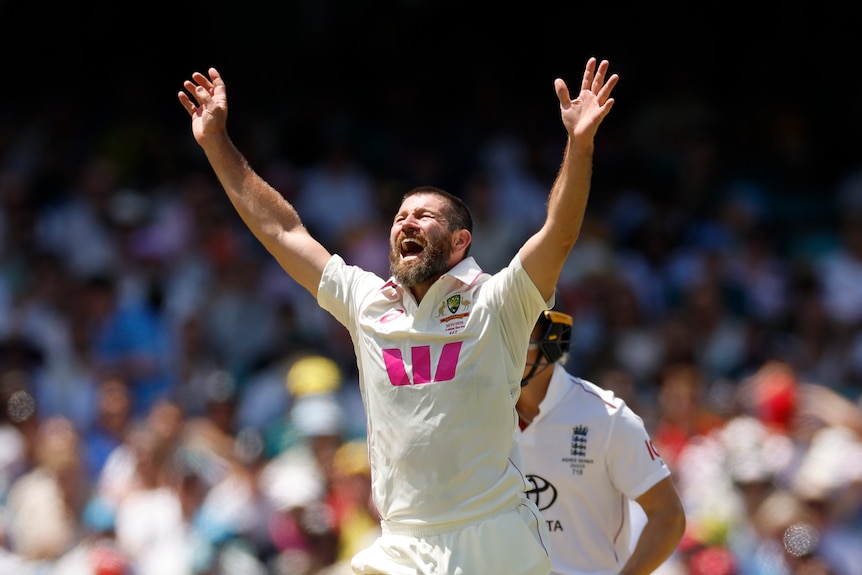 Australia bowler Michael Neser puts his hands in the air to celebrate a wicket during the Ashes Test at the SCG.
