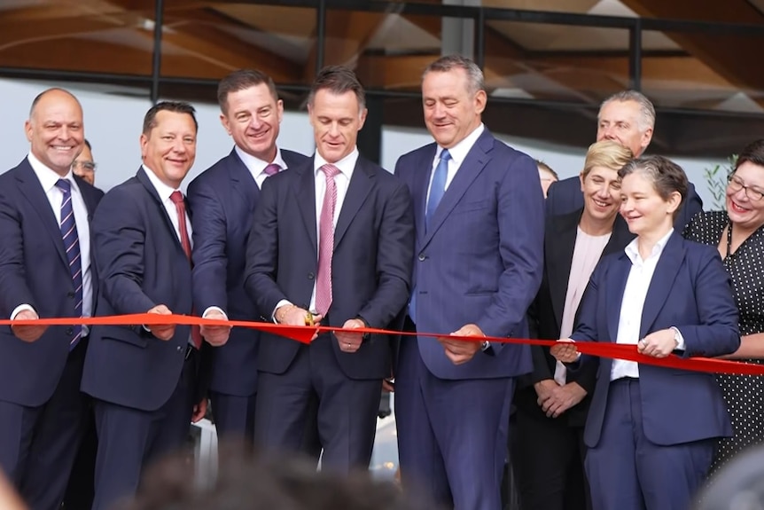 NSW Premier Chris Minns cutting the ribbon to the new Sydney fish market.